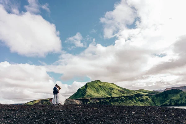 Hermosa pareja de boda de pie juntos y majestuoso paisaje en Islandia - foto de stock