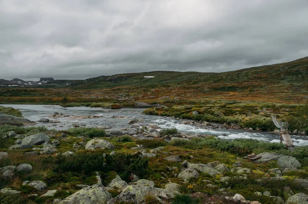 Córrego do rio passando por pedras e colinas no campo, Noruega, Hardangervidda National Park — Fotografia de Stock
