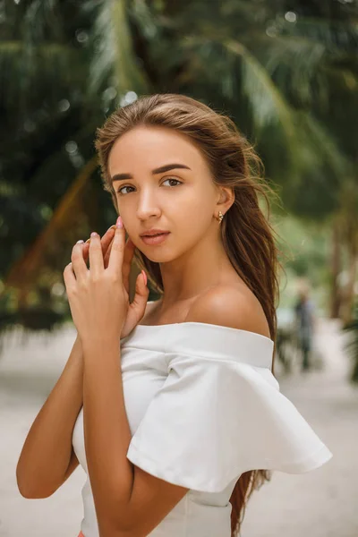 Portrait of beautiful young girl posing on sandy beach — Stock Photo