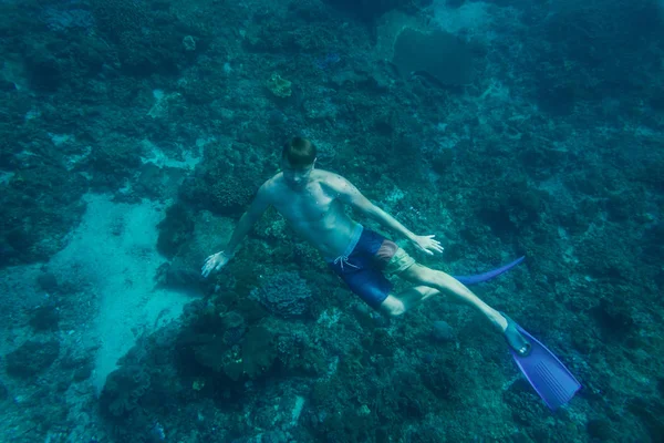 Jeune homme en palmes plongeant seul dans l'océan — Photo de stock
