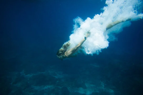 Foto submarina de un joven buceando solo en el océano - foto de stock