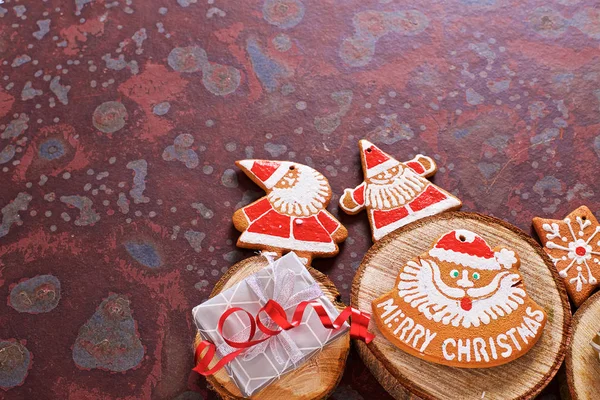 Homemade Christmas cookies, gifts  on a brown slate table.