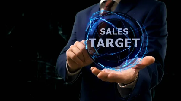 Businessman shows concept hologram Sales target on his hand — Stock Photo, Image