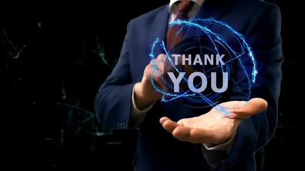 Businessman shows concept hologram Thank you on his hand — Stock Photo, Image