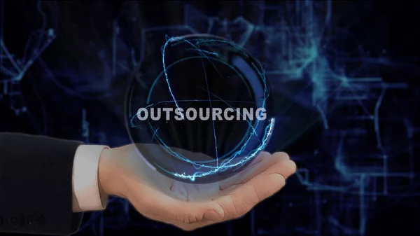 Mano pintada muestra concepto holograma Outsourcing en su mano —  Fotos de Stock
