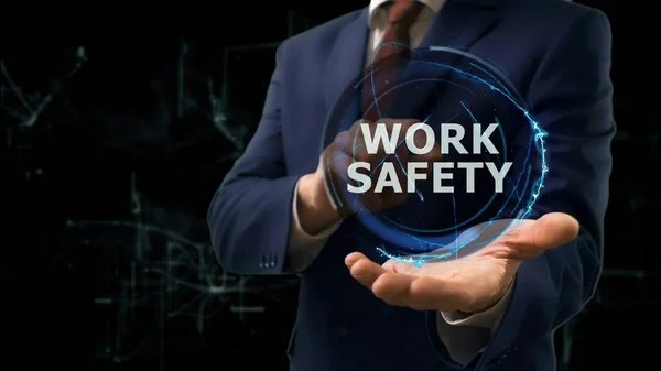 Businessman shows concept hologram Work safety on his hand — Stock Photo, Image