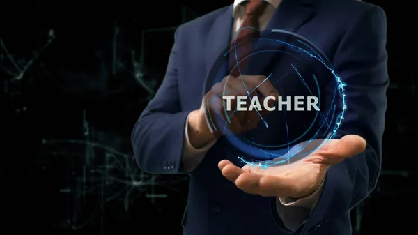 Бізнесмен показує концептуальну голограму Вчитель на руці — стокове фото