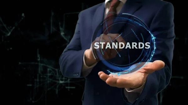 Affärsman visar konceptet hologram standarder på handen — Stockfoto