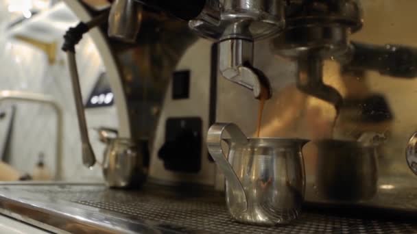 Coffee is poured into a metal cup — Stock Video