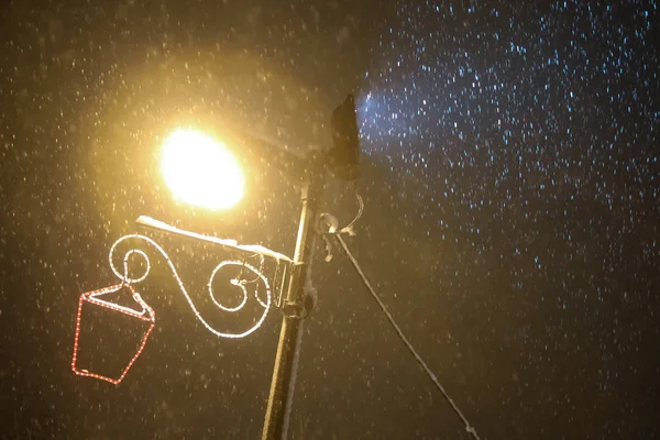 Illuminating street lamp in snowfall — Stock Photo, Image