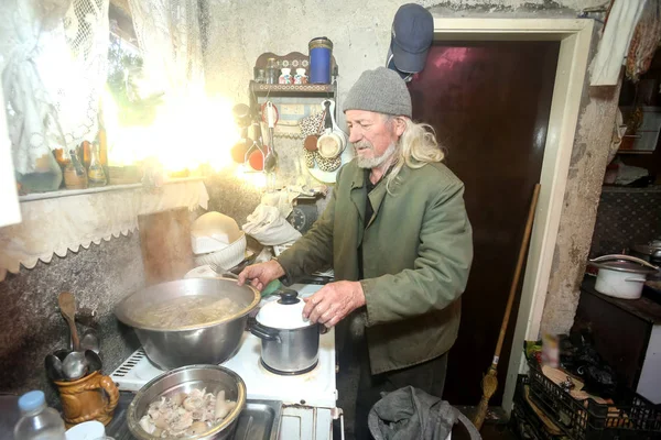 Oude man koken van vlees — Stockfoto
