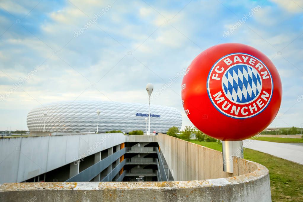 MUNICH, GERMANY - MAY 9, 2017 : A red sphere with Bayern Munchen logo in front of the Allianz Arena football stadium in Munich, Germany. The Allianz Arena is home football stadium for FC Bayern Munich.