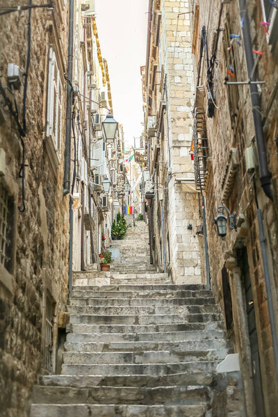 A view of a street full of steps in the old city core in Dubrovnik, Croatia.