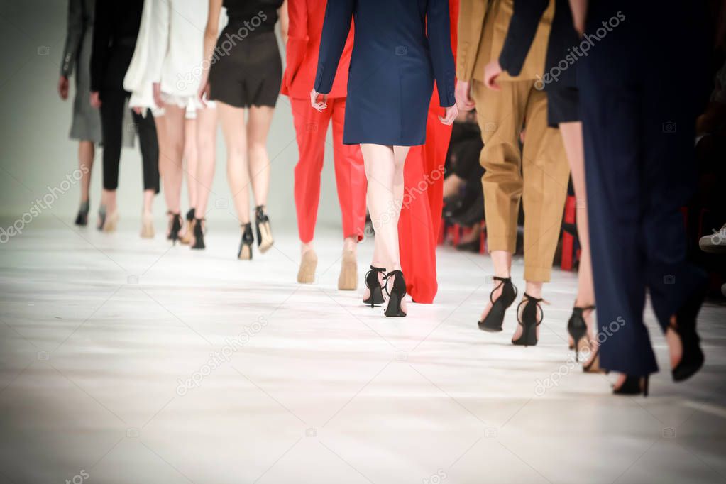 Detail of lined up rear view fashion models legs