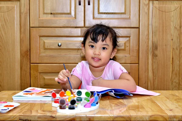 Милая молодая азиатская девушка рисует картину — стоковое фото