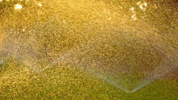 Разбрызгиватель для воды, освещенный солнцем Лицензионные Стоковые Изображения