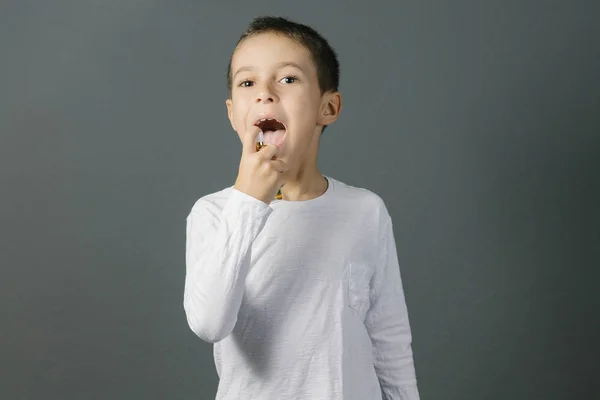 Child using spray for bad breath — Stock Photo, Image