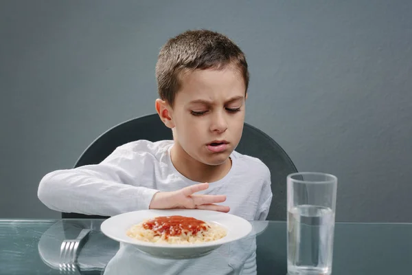 Portrait of child with no appetite in front of the meal. Concept — Stock Photo, Image