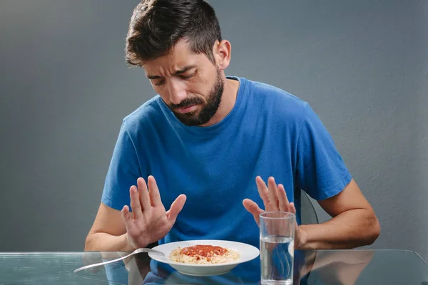 Portrait of man with no appetite in front of the meal. Concept o Stock Picture