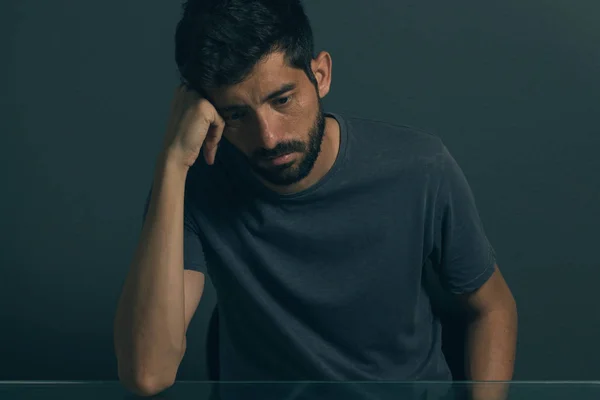 Sad man sitting in dark room. Depression and anxiety disorder concept — Stock Photo, Image