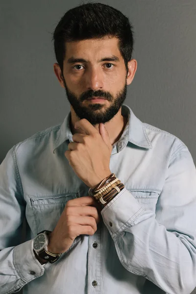 Advertising leather bracelets concept. Portrait of young man wearing leather bracelets and wrist watch.