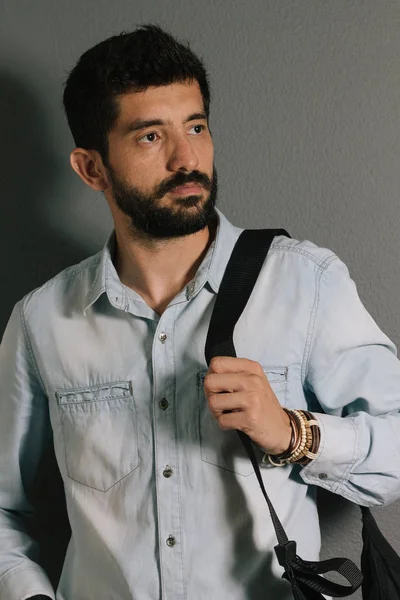 Advertising leather bracelets concept. Portrait of young man wearing leather bracelets and wrist watch.