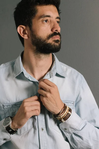 Advertising leather bracelets concept. Portrait of young man wearing leather bracelets and wrist watch.