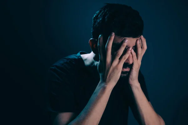 Close up of sad man in dark room. Depression and anxiety disorder concept — Stock Photo, Image