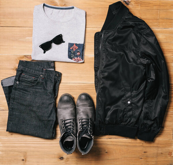 Flat lay set of men`s clothes and accessories on wooden backgrou