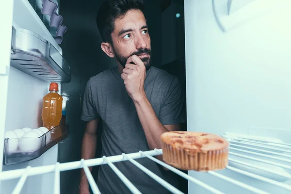 Hungrig man öppnar kylskåpet på natten — Stockfoto