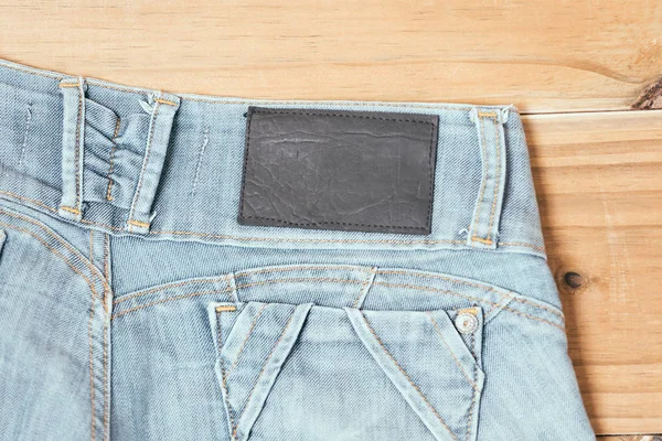 Kvinnliga blå trasiga jeansshorts på gamla trä bakgrund — Stockfoto