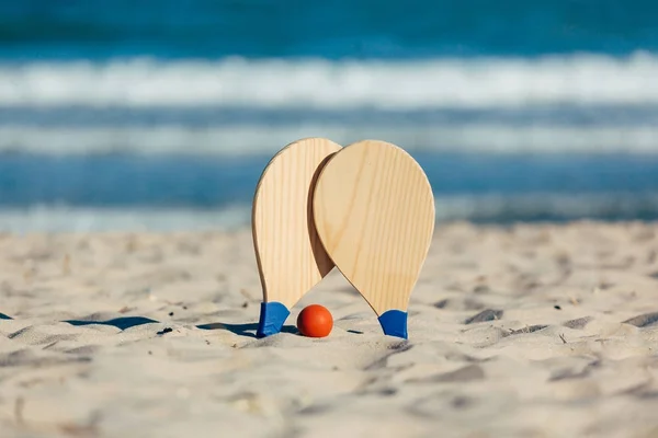 Beach tennis, beach paddle ball, matkot. Beach rackets and ball on the beach