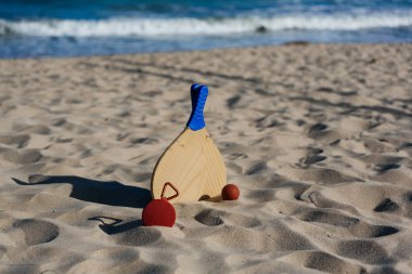 Kablosuz taşınabilir hoparlör ve plaj tenis raketleri sahilde