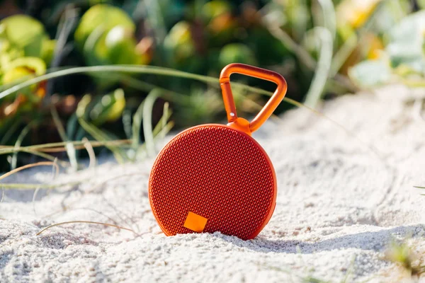 Portable wireless speaker on the beach