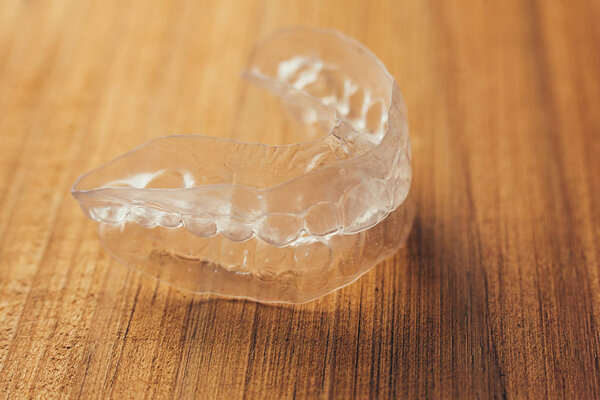 Individual teeth tray for whitening on wooden background