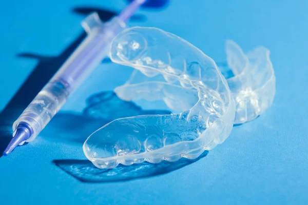 Individual teeth tray for whitening on blue background — Stock Photo, Image