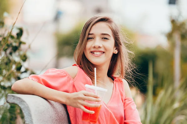 12 years old teenage girl drinking juice outdoors — Stock Photo, Image