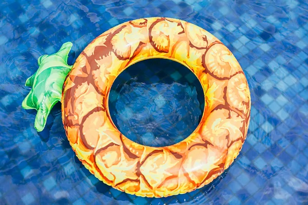 Ananasbecken schwimmt, Ring schwimmt in einem erfrischenden blauen Pool — Stockfoto