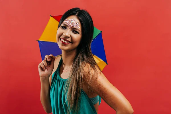 Молодая женщина празднует бразильский карнавал с зонтиком Frevo — стоковое фото