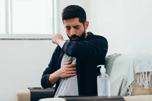 Sick man coughing in his arm joint to avoid spreading coronavirus. Covid-19.