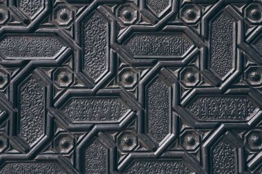 close-up shot of black wall with carved arabesque pattern clipart