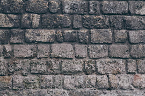 close-up shot of black aged brick wall for background