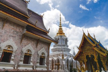 building of beautiful thai temple on sunny day clipart