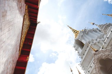 bottom view of beautiful thai temple on sunny day clipart
