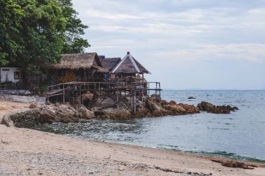 Bulutlu gün deniz sahilinde rahat ahşap shacks