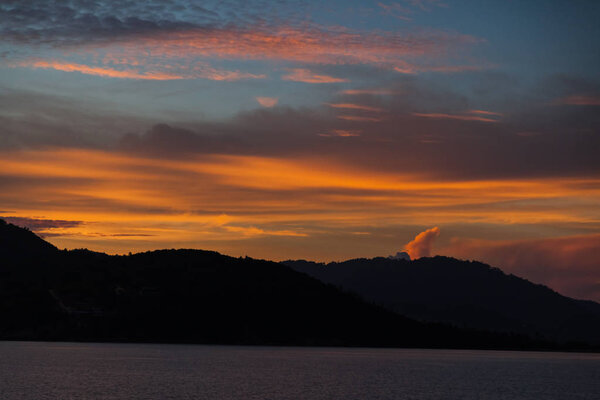 dark hills silhouette under sunset sky