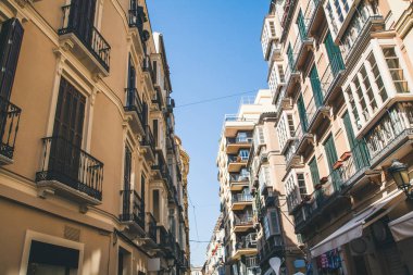 low angle view of buildings on street, spain clipart