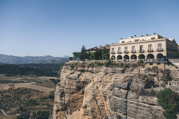 scenic view of building on rock against mountains landscape, Ronda, spain