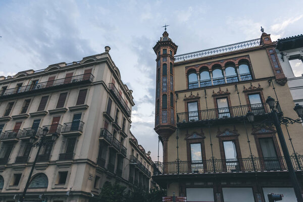 buildings facades under beautiful cloudy sky, spain