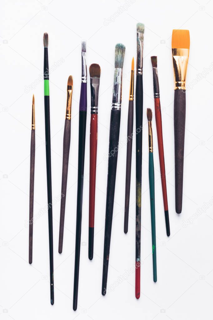 close-up view of various professional paint brushes isolated on white